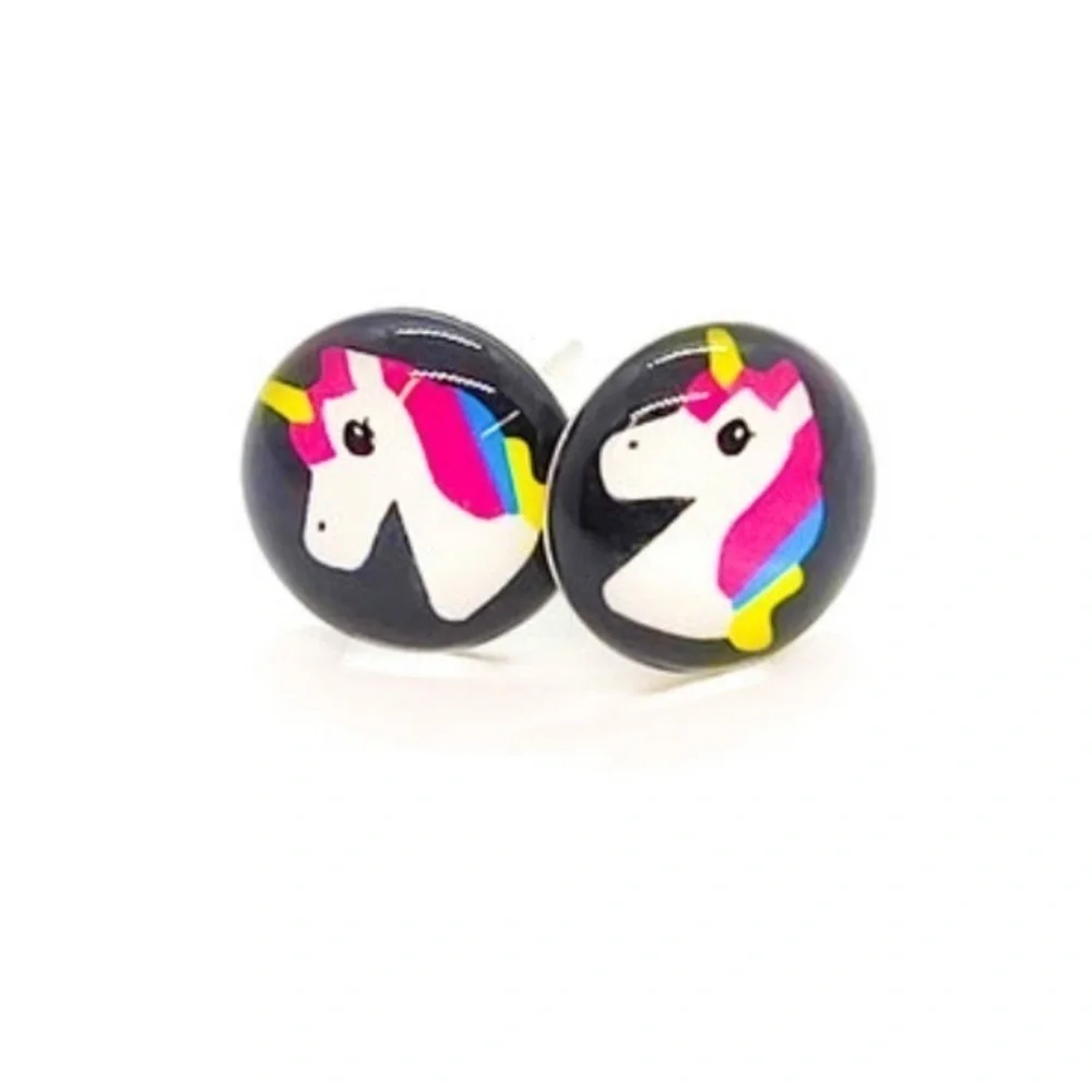 Unicorn stud earrings on black background